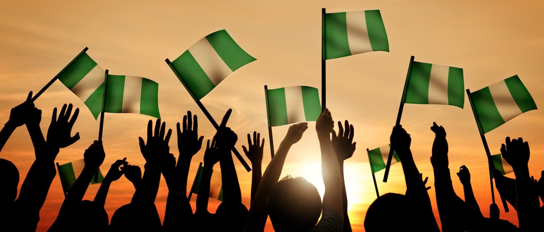 hands raising nigerian flags